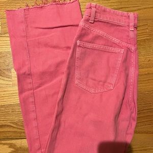 High-waisted pink full length jeans.